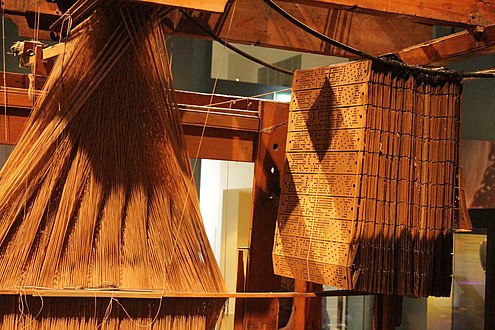 A_Jacquard_loom_showing_information_punchcards.jpeg